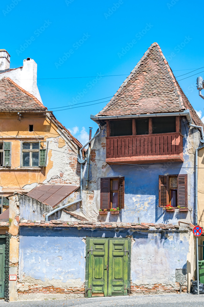 Beautiful medieval houses on a sunny summer day with blue sky in Sibiu, Romania