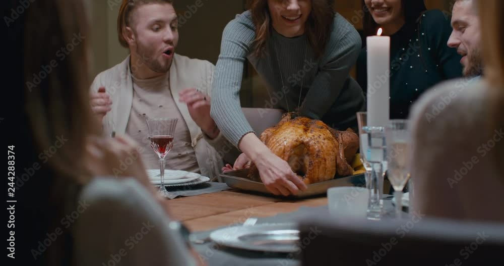 Sisters or friends holding tray with huge turkey for thanksgiving dinner, happy large family cheering. 4K UHD 60 FPS SLOW MOTION Blackmagic RAW