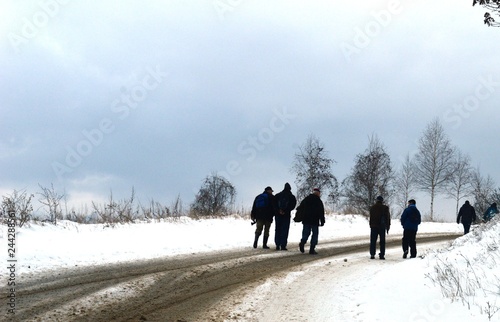 people on the street in winter in the snow