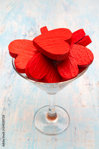 Red hearts in a glass goblet.
