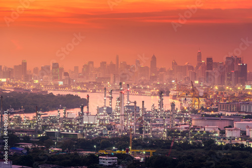 Oil gas refinery manufacturing industry plant in twilight scene in Bangkok city of Thailand.  Business factory petrochemical or energy power industrial and heavy construction onshore in cityscape.