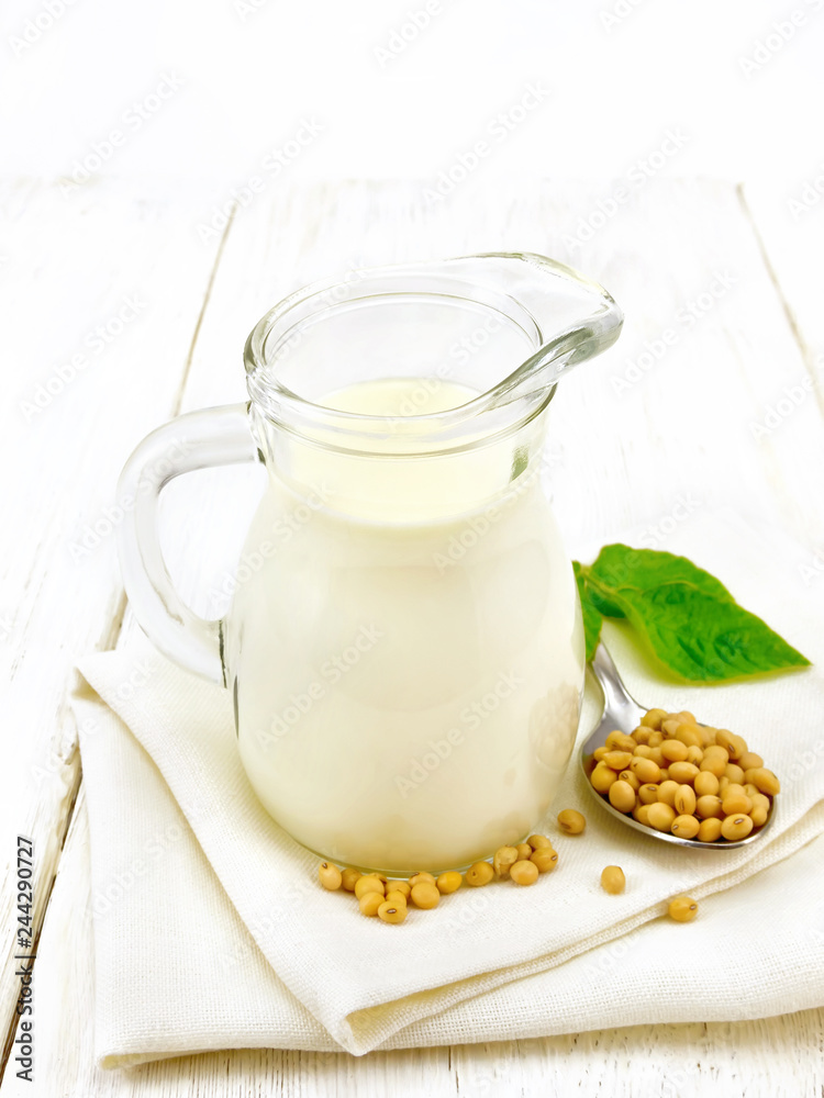 Milk soy in jug with leaf on board Milk soy in jug with leaf on board