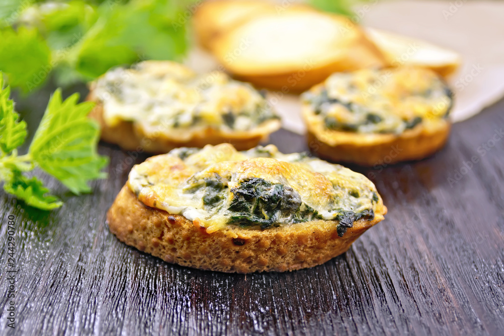 Sandwich of nettle and cheese on dark board Sandwich of nettle and cheese on dark board