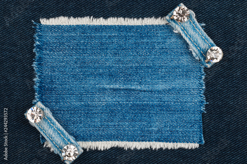 Denim frame with fringe and two belts with rhinestones.