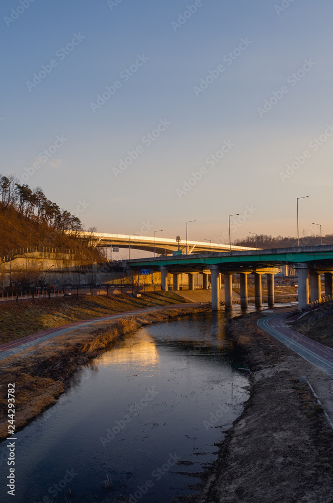Highway on river at late afternoon sunset