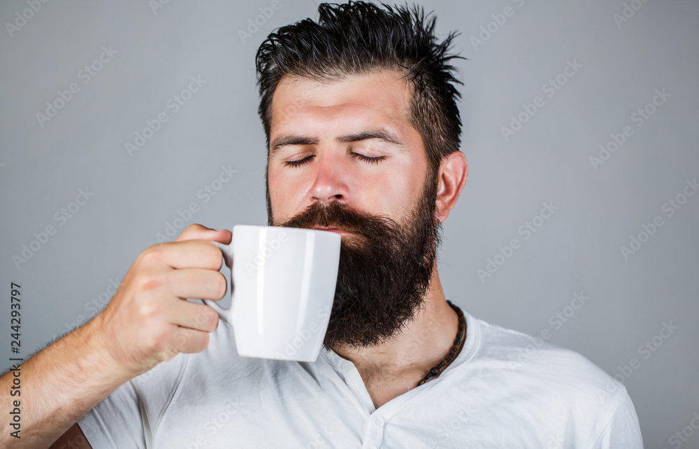 Good morning, man holding a cup tea. Morning concept. Handsome bearded male holds cup of coffee, tea. Smiling hipster man with cup of fresh coffee. Bearded man smiling. Portrait male. Closeup tea. Good morning, man holding a cup tea. Morning concept. Handsome bearded male holds cup of coffee, tea. Smiling hipster man with cup of fresh coffee. Bearded man smiling. Portrait male. Closeup tea.