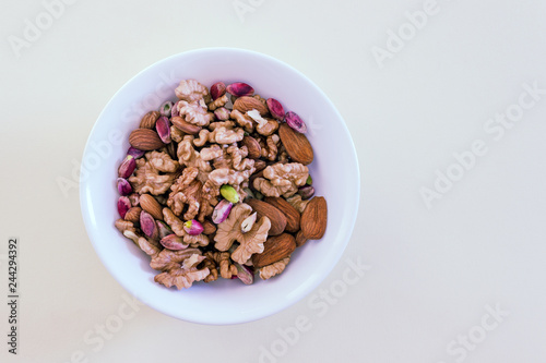 Different types of nuts- assorted walnuts, almonds and pistachios. Concept- healthy diet, full source of vegetable protein in vegetarianism and raw food.