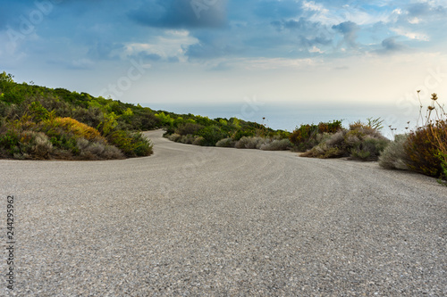Curved road with ocean water landscape view