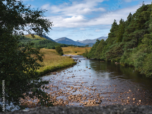Scottish mountain scenery with the river in the foreground overlooking a mountainous valley. The river Linne Nam Beatach from Victoria Bridge Inveroran, Highland, Scotland, UK - image 