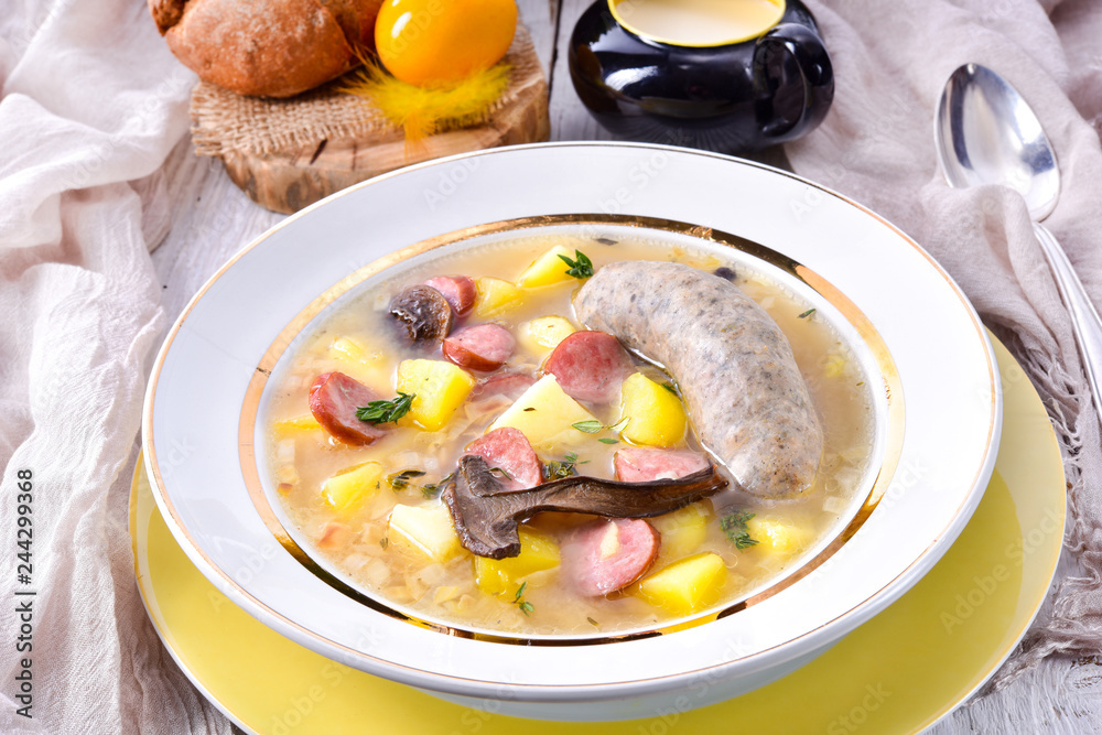 a polish easter soup with homemade white sausage and mushrooms