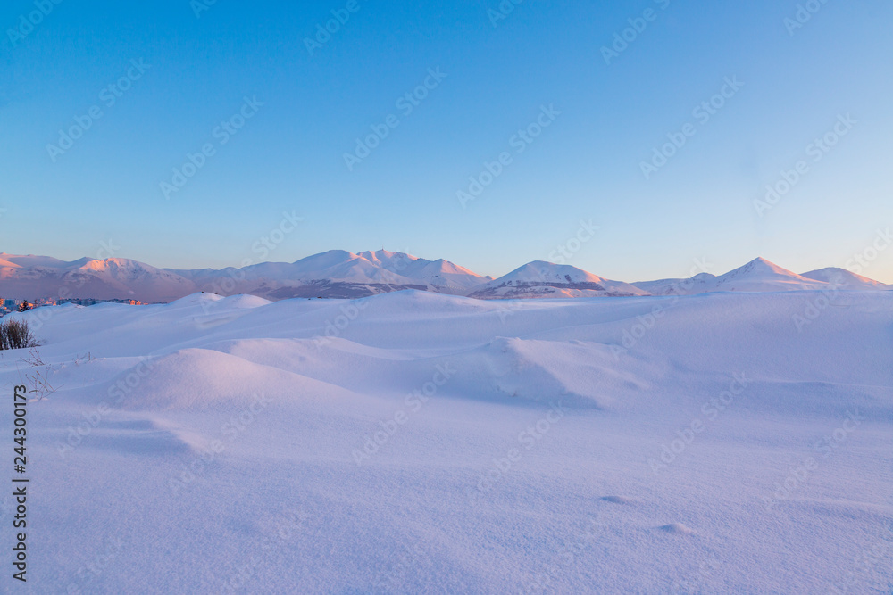 Snow dunes with palandoken mountains background in Erzurum, Turkey