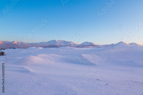 Snow dunes with palandoken mountains background in Erzurum, Turkey