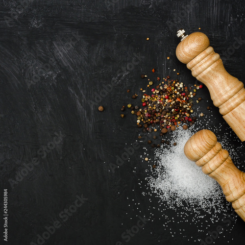 Wooden salt shaker and pepperbox on black chalk board. photo