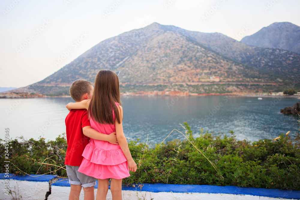 Girl and boy together outdoors. small brother embracing older sister. Girl and boy together outdoors. small brother embracing older sister.