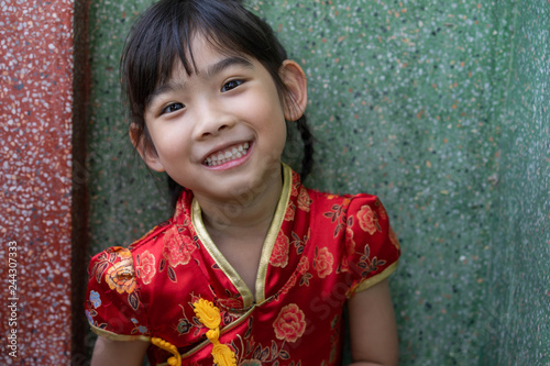 Asian adorable child girl In Chinese dress happy smile