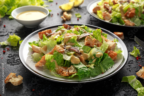 Caesar salad with chicken, anchous fish, croutons, parmesan cheese and greens. healthy food