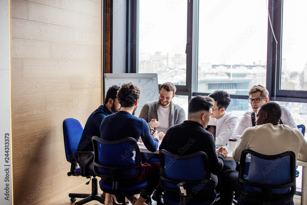 Business Team Meeting Brainstorming Togetherness Concept. Office workers discussing new business plan together in a conference room. Business Team Meeting Brainstorming Togetherness Concept. Office workers discussing new business plan together in a conference room.
