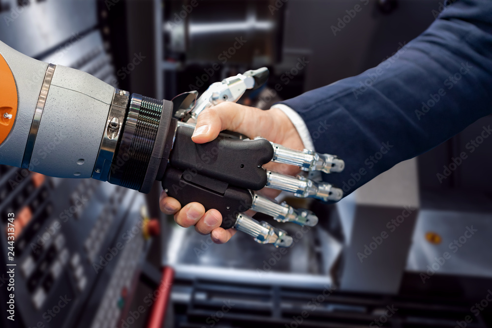 Hand of a businessman shaking hands with a Android robot. Hand of a businessman shaking hands with a Android robot.