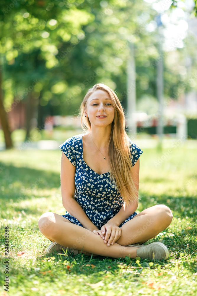 Happy woman with beautiful blonde hair smiling in the summer park Happy woman with beautiful blonde hair smiling in the summer park