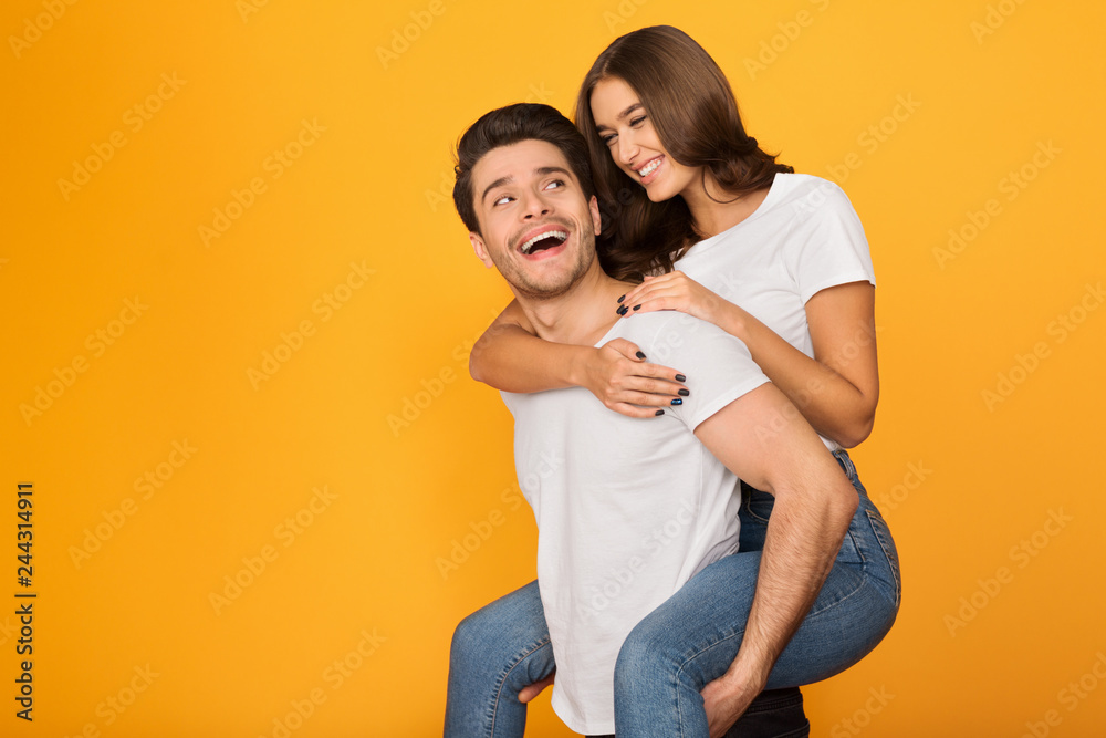 Happy man carrying his girlfriend on the back Happy man carrying his girlfriend on the back