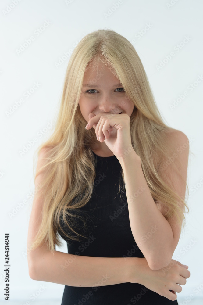 girl in black swimsuit with white hair smiling and showing emotions in the Studio girl in black swimsuit with white hair smiling and showing emotions in the Studio