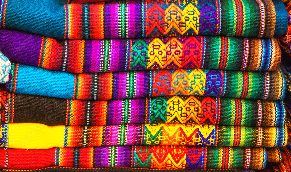 Peruvian traditional colourful native handicraft textile fabric at market in Machu Picchu, one of the New Seven Wonder of The World, Cusco Region Peru, South America. Selective focus, Close up.