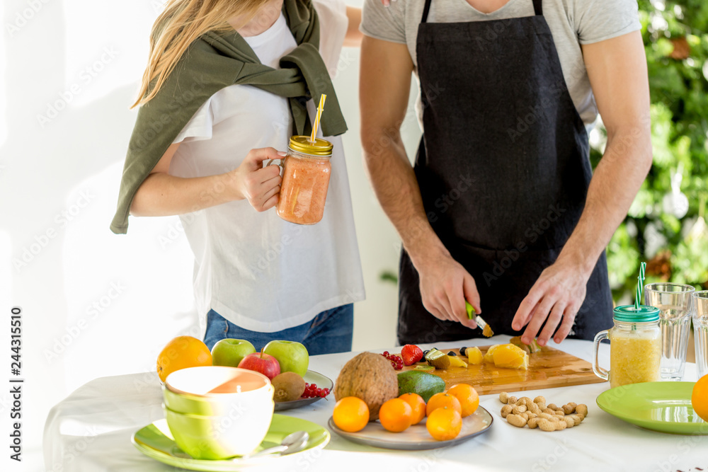 fruit mix on the table. two people making nutritious snakcs. cropped photo fruit mix on the table. two people making nutritious snakcs. cropped photo