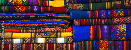 Peruvian traditional colourful native handicraft textile fabric at market in Machu Picchu, one of the New Seven Wonder of The World, Cusco Region Peru, South America. Selective focus, Close up.