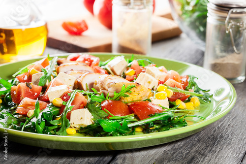 Fresh salad with chicken breast, arugula and tomato