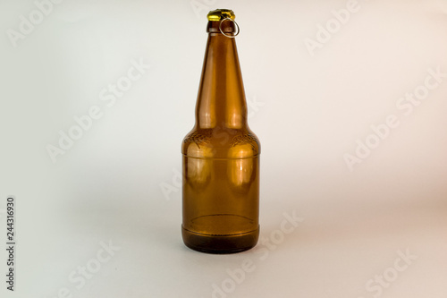 Empty bottle of brown color on a white background with an open cap