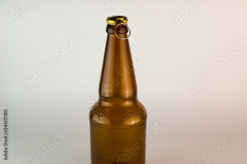 Empty brown bottle on white background with open lid close-up