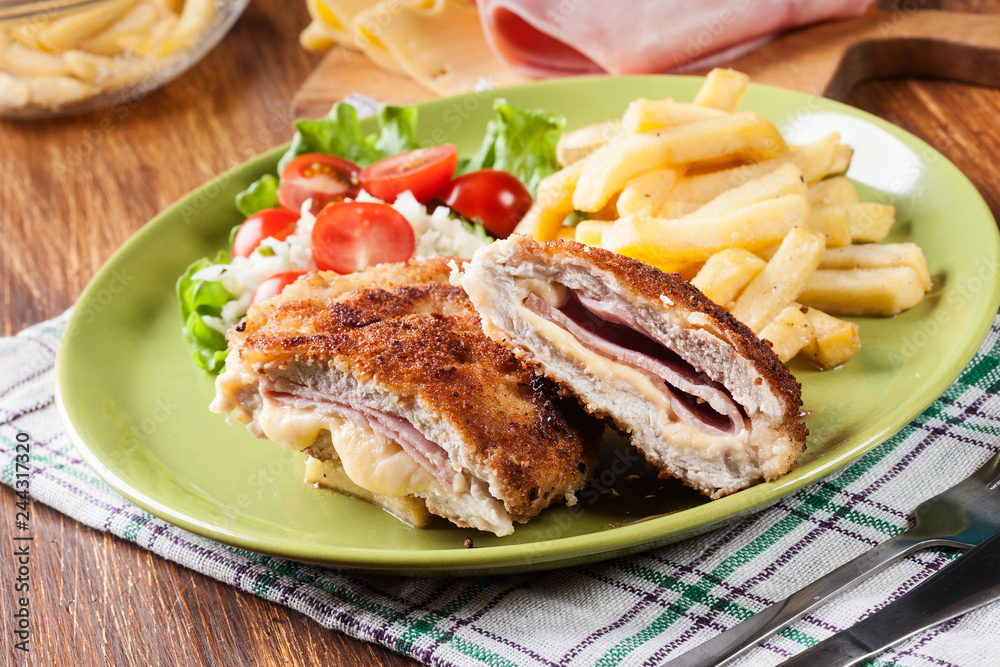 Cutlet Cordon Bleu with pork loin served with French fries and salad