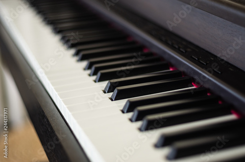 Close up view of electric piano black and white Keys with blurred background 