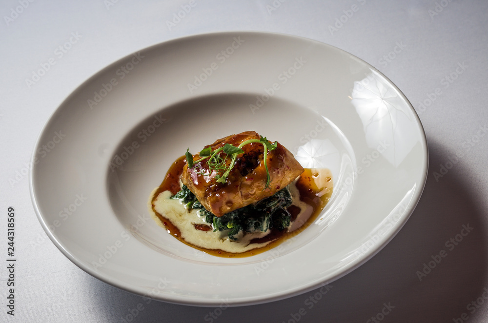 Pike perch with ginger and honey on spinach