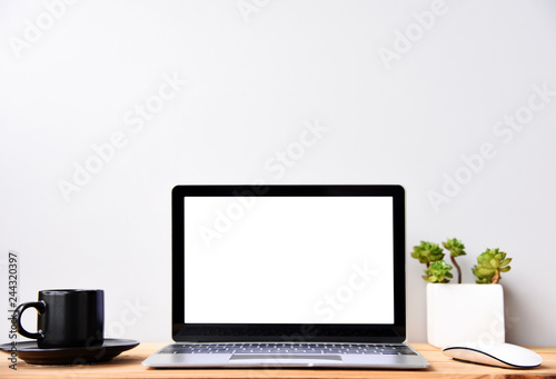 blank screen Modern laptop computer with mouse,Smart phone and Succulent on wood table in office view backgrounds