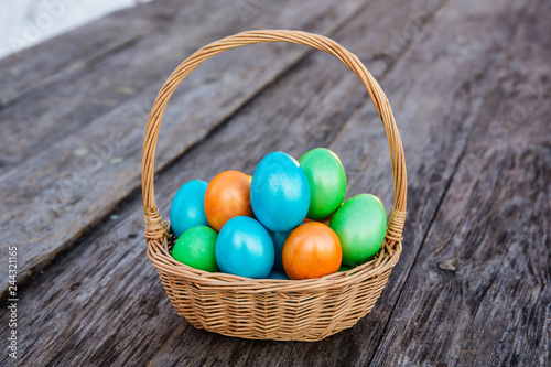 Wallpaper Mural Colorful Easter egg in the basket on wooden background Torontodigital.ca