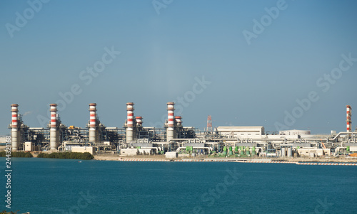 Power plant at a pond. Landscape with big chimneys.