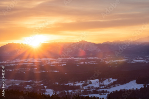 Sunrise at the Hohenpeißenberg, a mountain in Bavaria. A perfect view zo the bavarian alps with red morning glow in the sky.