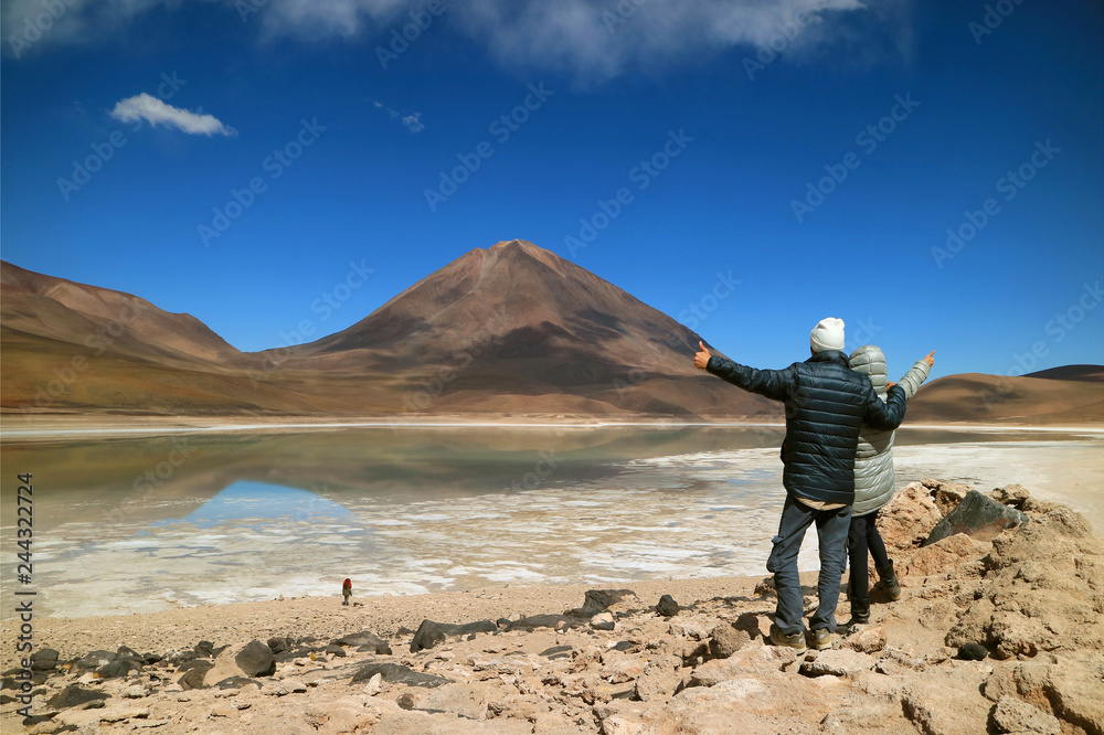 Young Tourist Couple Very Excited to See the Color of Water in the Lake Changing, Laguna Verde or Green Lake, Potosi, Bolivia 