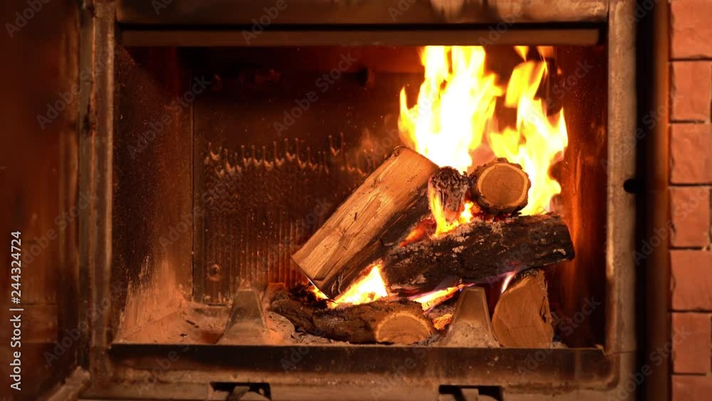 A fire burns in a fireplace
