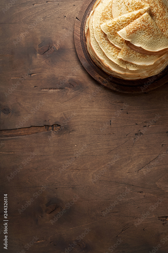 Stack of russian pancake blini on a wooden background