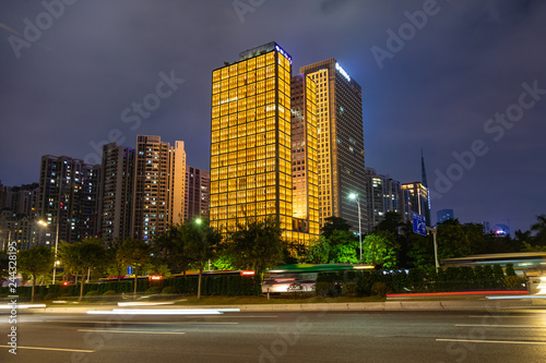 Beautiful street at night with light trails in Guangzhou central business district. Image of blur motion of cars on the city road. © umike_foto