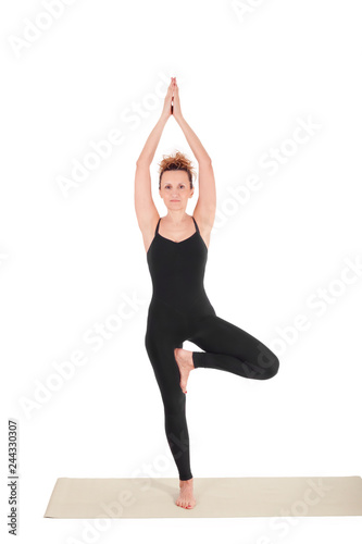 Beautiful Yoga: Senior Woman doing Vrikshasana, The Tree Pose