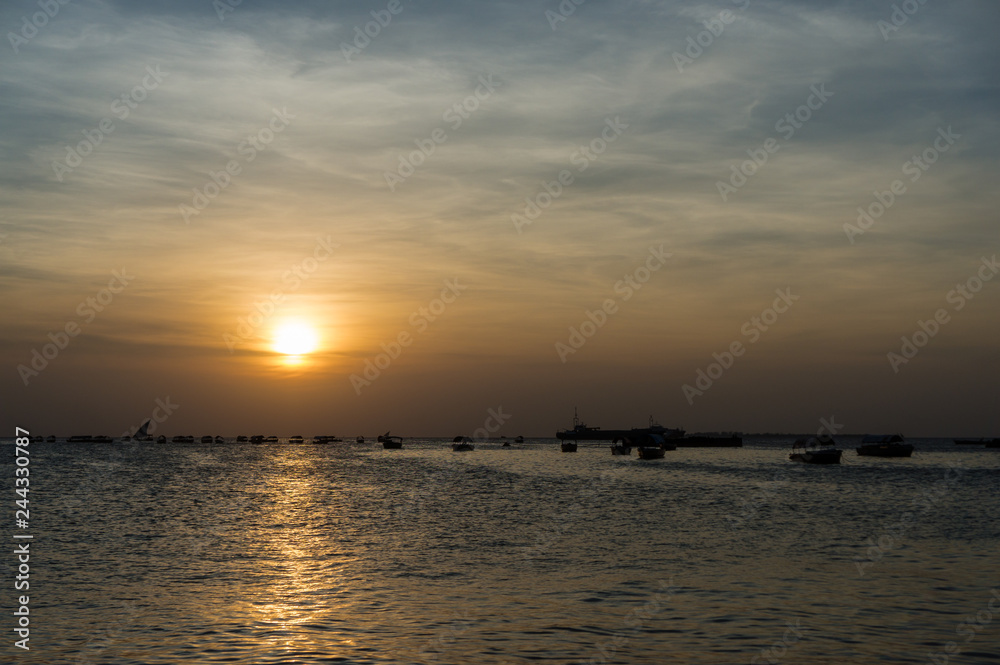Silhouette of a traditional Dhow sailing boats,beautiful sunset, Stone Town, Zanzibar, Tanzania.