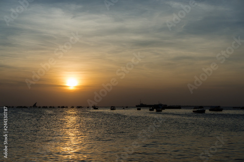 Silhouette of a traditional Dhow sailing boats,beautiful sunset, Stone Town, Zanzibar, Tanzania.