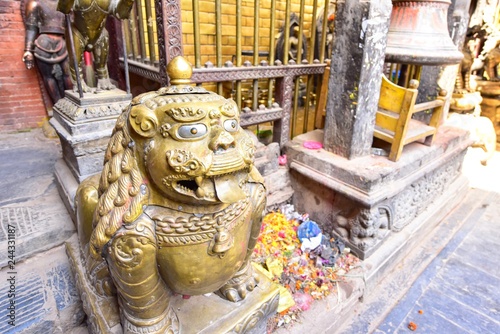 Golden Mythical Guardian Statue at the Golden Temple in Patan, Nepal photo