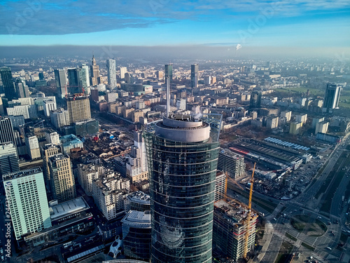 WARSAW, POLAND - NOVEMBER 27, 2018: Beautiful panoramic aerial drone view to the center of Warsaw City and The Warsaw Spire - 220 metre neomodern office building on European square (Plac Europejski) photo