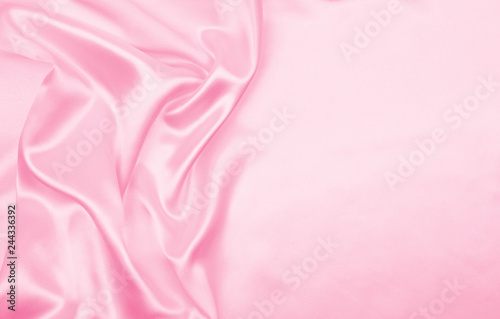 Smooth elegant pink silk or satin texture as wedding background. Luxurious valentine day background design