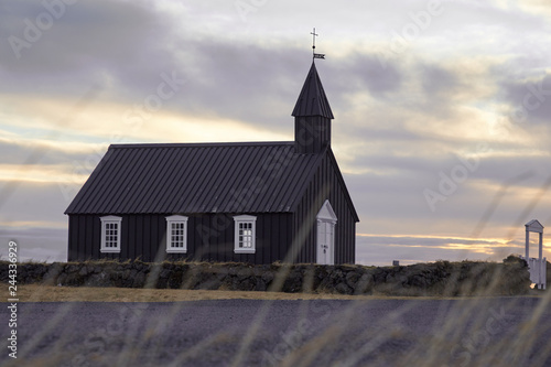 Famous picturesque black church of Budir at Snaefellsnes peninsula region in Iceland during strong wind and dramatic sky