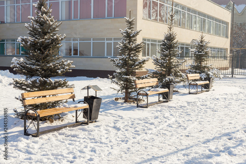 Benches in the winter city park. Snowbound. Snow covered trees © donikz